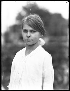 Outdoor portrait shot of an unidentified little girl in a white dress