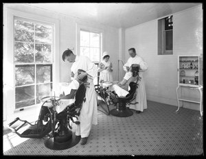 Two patients being examined, Dentist