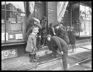 Unidentified boys shooting craps on a stoop, New York City, May 30, 1915