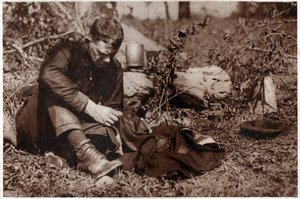 Tramp repairing his clothes