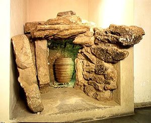 Reconstruction of an Etruscan tomb with an urn by after Etruscan