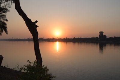Golden Sunset Reflections on a Tranquil River by Albert Mansour