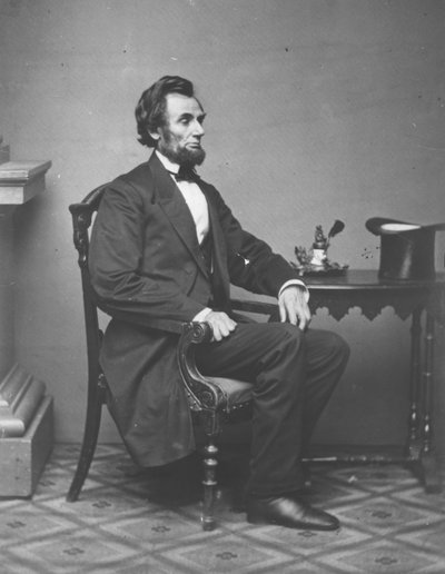 Abraham Lincoln, full-length portrait, seated by Alexander Gardner