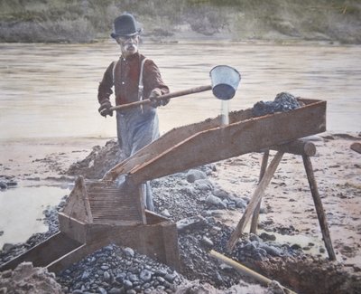 American gold prospector using a sluice box by American Photographer