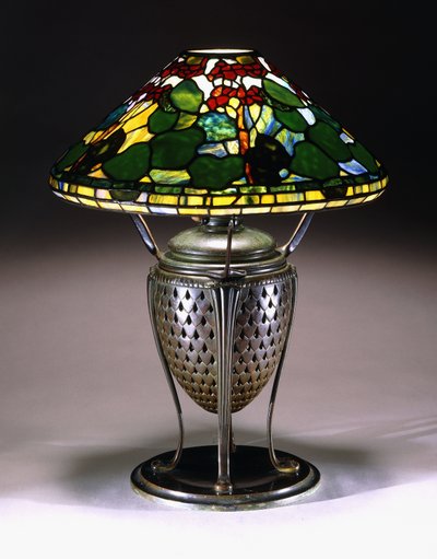 A "Geranium" table lamp with a conical shade, and reticulated bronze urn base with a fishscale pattern, 20th century by American School