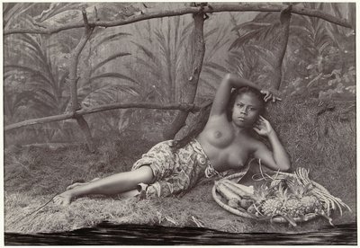 Portrait of an Unknown Half-Naked Indonesian Woman, Lying with a Fruit Basket in a Decor by Anonymous
