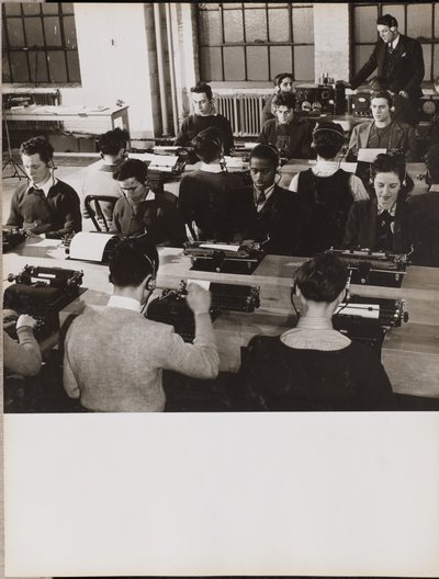 People sit in front of typewriters while wearing headphones by Arnold Eagle