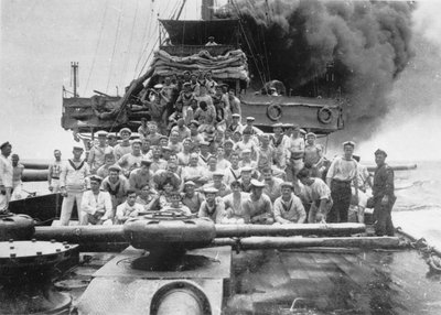 Group portrait of some unidentified members of the crew of HMAS Sydney, shown on the deck while their ship is chasing the collier Buresk near Cocos Island, 9 November 1914 by Australian Photographer