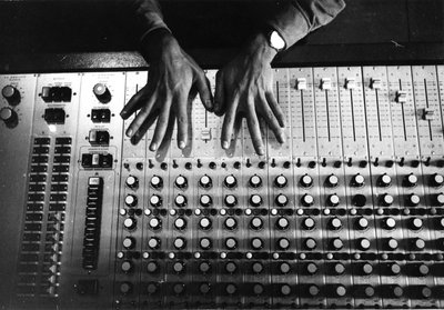 Hands on the mixing console by Bernard Perrine