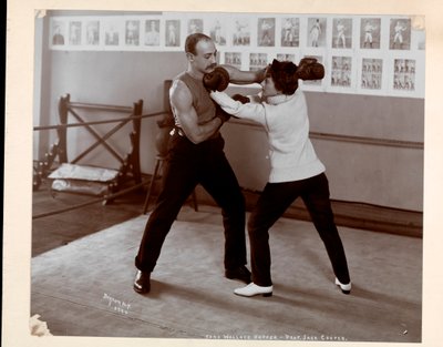 Edna Wallace Hopper posed in a boxing ring with Jack Cooper at his gymnasium at Broadway and 37th Street, New York, 1899 by Byron Company