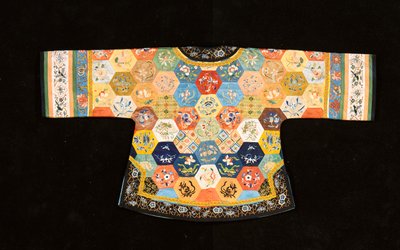 A Chinese informal patchwork coat, composed of hexagons of embroidered silks by Chinese School