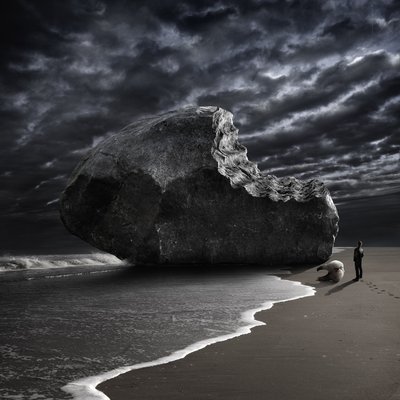 Bitten Rock on Stormy Beach by Christophe Kiciak