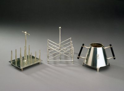 Toast rack with upright supports, manufactured by Hukin & Heath; triangular section toast rack, manufactured by Elkington & Co.; sugar bowl with ebonised wood by Christopher Dresser