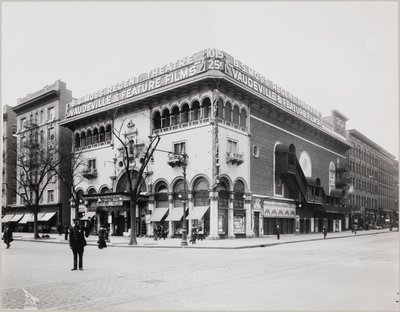 A huge theater with an elaborate facade, complete with Moorish arches and balconies. A large sign on top of the building reads 