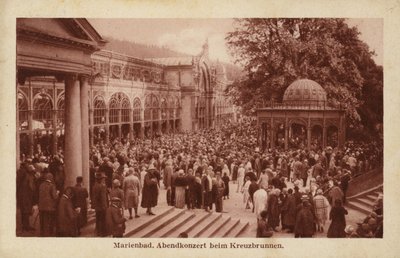 Postcard depicting a crowd of people attending an evening concert at Kreuzbrunnen by Czech Photographer