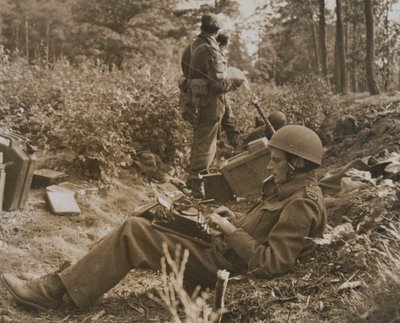 War correspondent Alan Wood typing out a despatch by D.M. Sgt. Smith