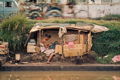 Cardboard hut, along a sewage canal, serves as a home. Jakarta, Indonesia by Dean Conger