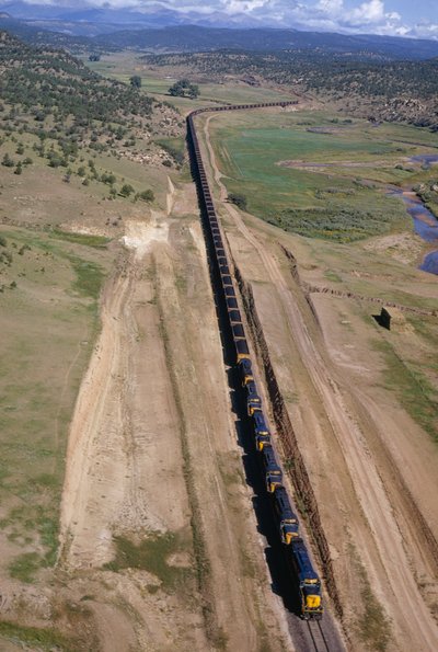 Mile-long unit train of Atchison, Topeka, Santa Fe line rumbles. Northern New Mexico. by Dean Conger