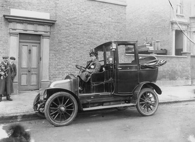A Driver Sitting at the Wheel of His Motor Car by English Photographer