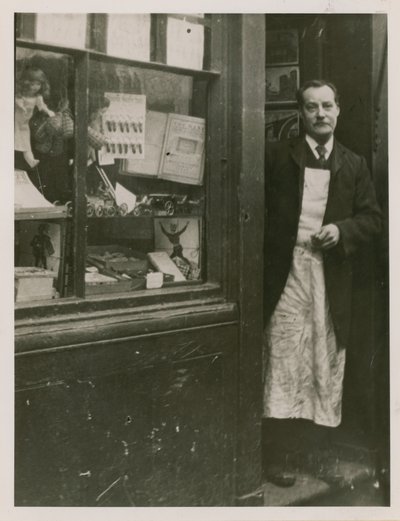 A Shopkeeper Standing in the Doorway of His Shop by English Photographer