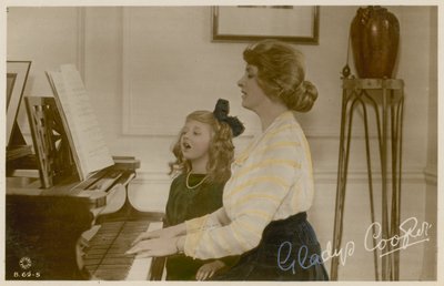 Gladys Cooper and girl at piano by English Photographer