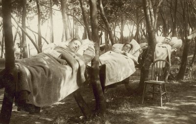 Hop pickers sleeping in hammocks on a farm in Kent by English Photographer