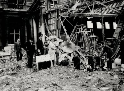 King George VI and Queen Elizabeth, together with Winston Churchill, surveying bomb damage, presumably to Buckingham Palace by English Photographer