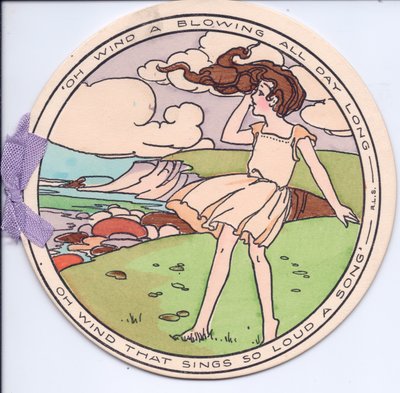 A circular die-cut Edwardian greeting card of a girl in the wind on a cliff top by English School