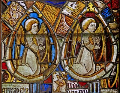 A panel in the east window depicting two musician angels with harps amid fragments by English School