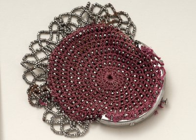 Pink purse with top clasp, bead decoration and mesh trim by English School