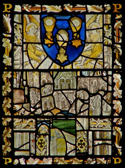 The east window depicting a shield with emblems of the Sacrament; fragments of canopy with figures by English School