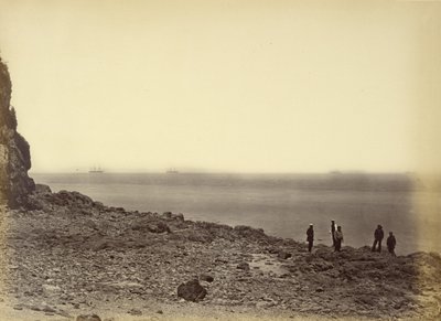 View of shore with ships on horizon and five figures standing on beach by Felice Beato
