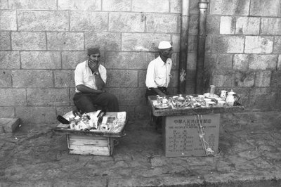 Street vendors in a street in Jerusalem by Fosco Maraini