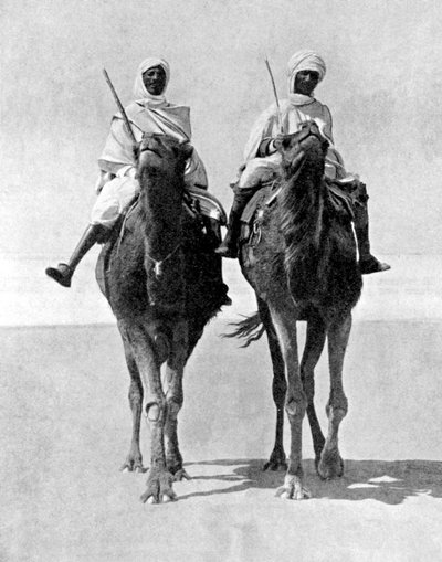 Two Arabs riding camels in the Sahara Desert, Africa, 1936 by Fox Photos