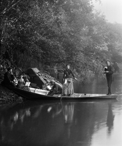 Group of friends, on a walk, resting on a boat by French Photographer