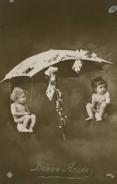 Happy New Year card with two babies hanging from an umbrella by French Photographer