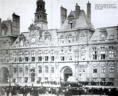 Inflating a balloon with the declarations of the Commune attached to it outside the Hotel de Ville, Paris by French Photographer