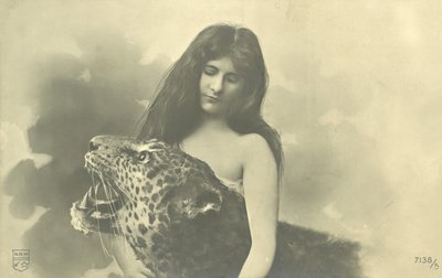 Long-haired girl with arms around stuffed leopard by French Photographer