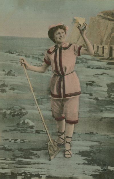 Woman holding a fishing net and shell (hand-coloured photo) by French Photographer