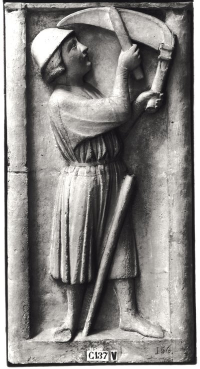 Peasant sharpening his scythe for the haymaking, representing the month of June, from the Portal of the Virgin on the West Facade by French School