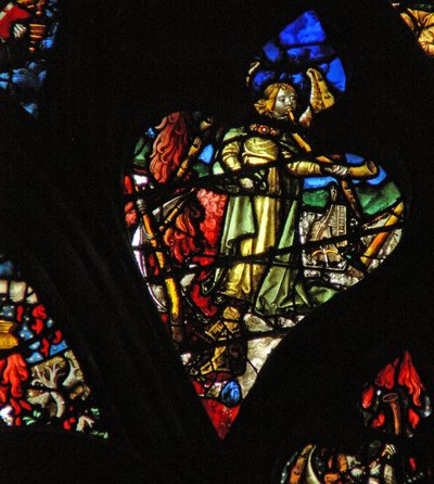 The west rose window depicting a scene from the Book of Revelation: Second trumpet; a burning mountain descends into the sea by French School