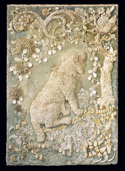 One of a pair of Louis XV seated dogs modelled in relief, within a grotto-like surround by German School