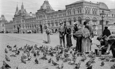 Feeding pigeons in Red Square, upper trading rows in backdrop by Gilbert H. Grosvenor