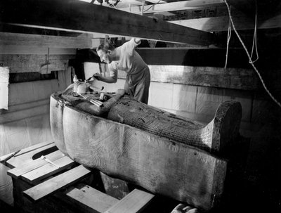 Discovery of the Tomb of Pharaoh Tutankhamun in the Valley of the Kings (Egypt): In Burial Chamber, Howard Carter Working on the Lid of the Second Coffin, October 1925, Photo by Harry Burton by Harry Burton