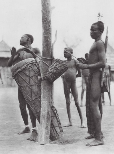 Africa: Moru men playing drums by Hugo Adolf Bernatzik