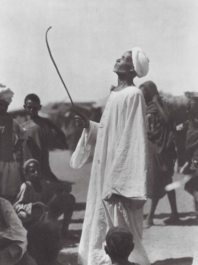 Africa: Old man mocking the dancer by Hugo Adolf Bernatzik