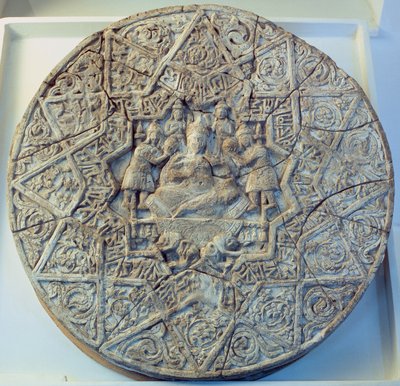 Sun disc depicting a king sitting cross-legged on a throne flanked by two angels in the centre, found at Ray, Iran by Islamic School