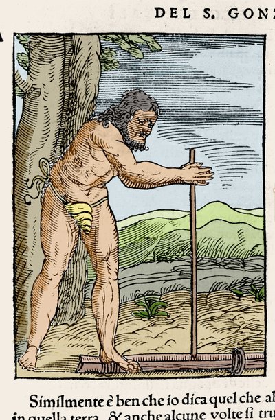 A native man lighting a fire by rubbing two pieces of wood. Engraving from 