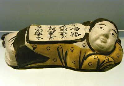 Ceramic, child-shaped pillow, with a poem evoking a night landscape (Photography by Leonard de Selva) by Jin Dynasty Chinese School