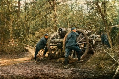 Three French soldiers in the woods with a Howitzer, Verdun, September 1916 by Jules Gervais Courtellemont